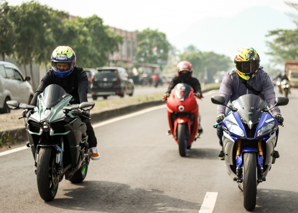 people riding motorcycle on road during daytime