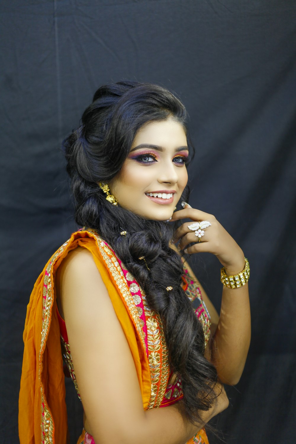 woman in orange and blue sari