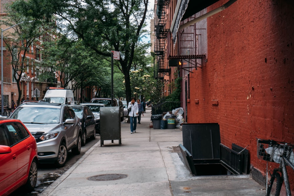 cars parked beside brown brick building during daytime