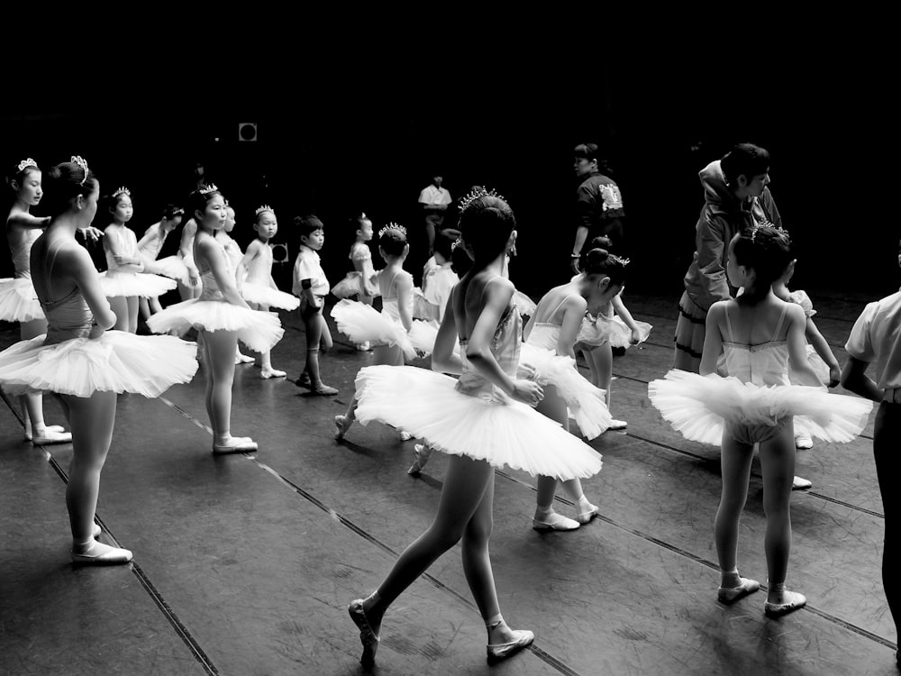 grayscale photo of woman in white dress dancing