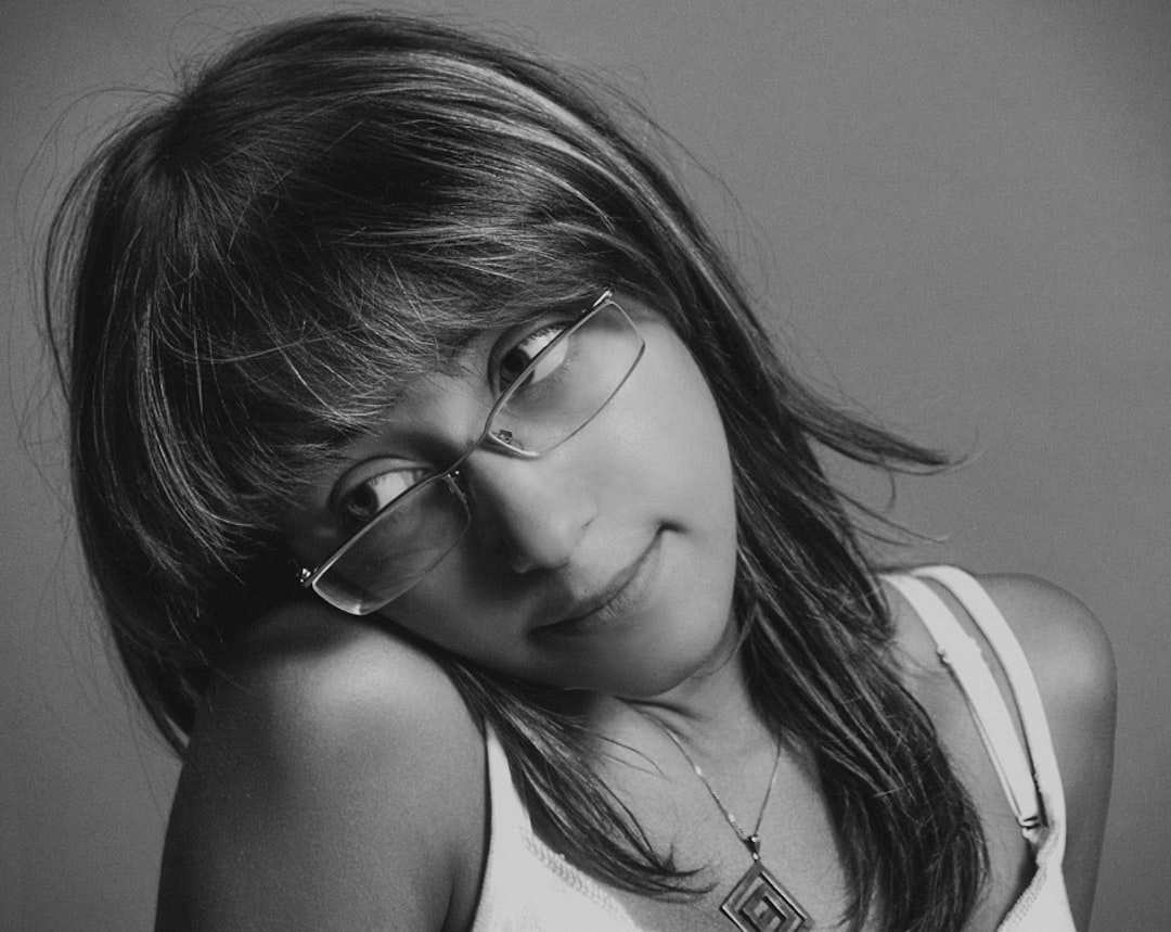 woman in white tank top wearing eyeglasses