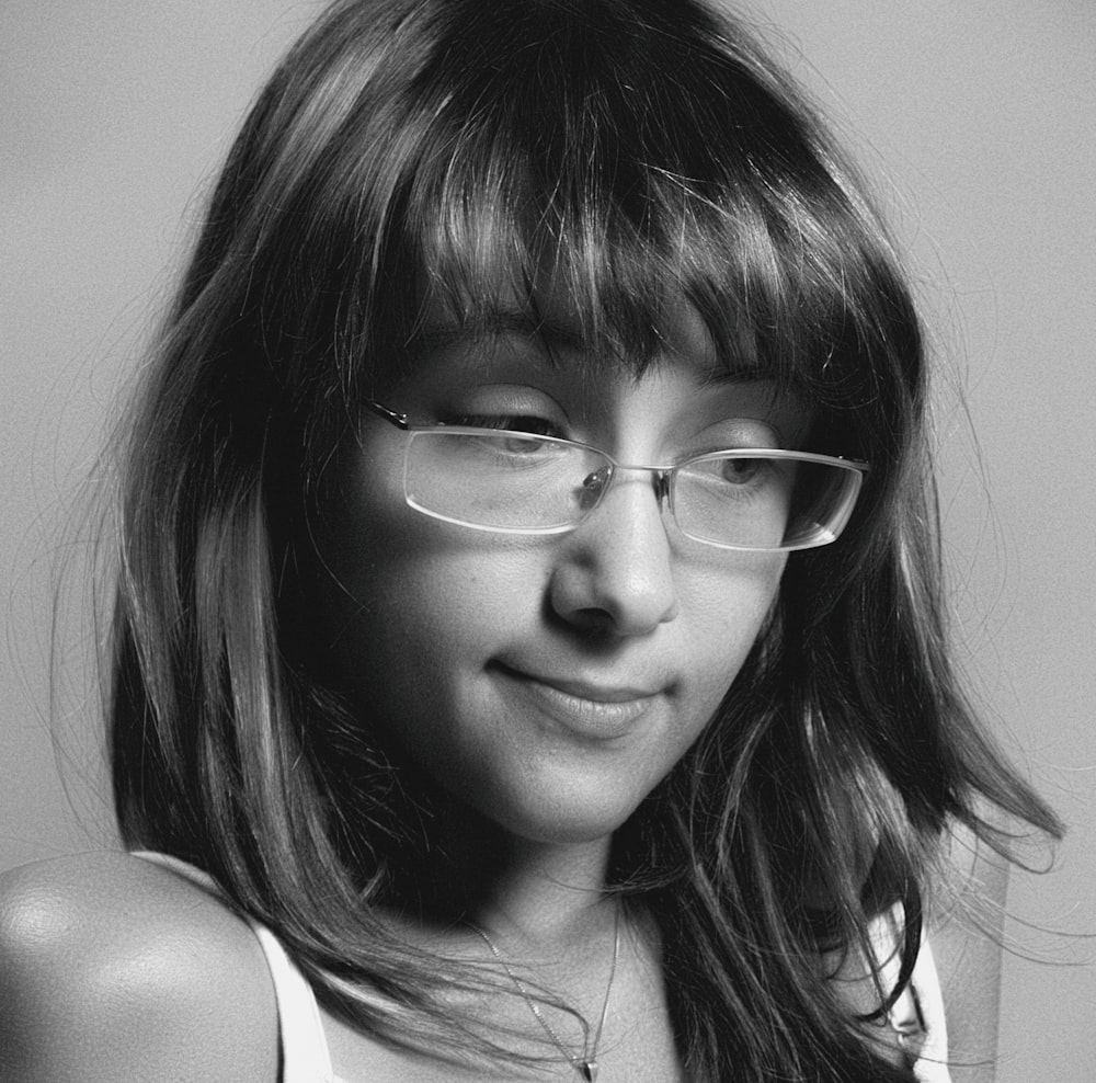 woman in white tank top wearing eyeglasses