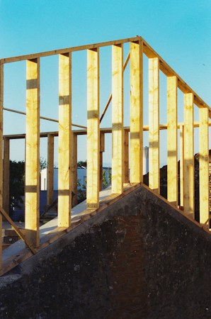 New house under construction with exposed wooden framing, like the new homes that carry a 23.3% premium over resale homes in Las Vegas