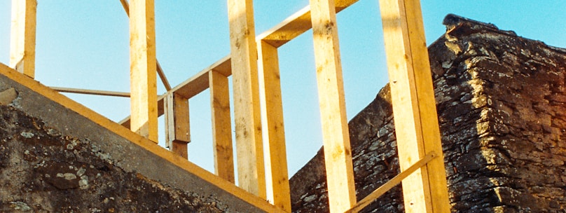 white metal ladder on gray concrete wall