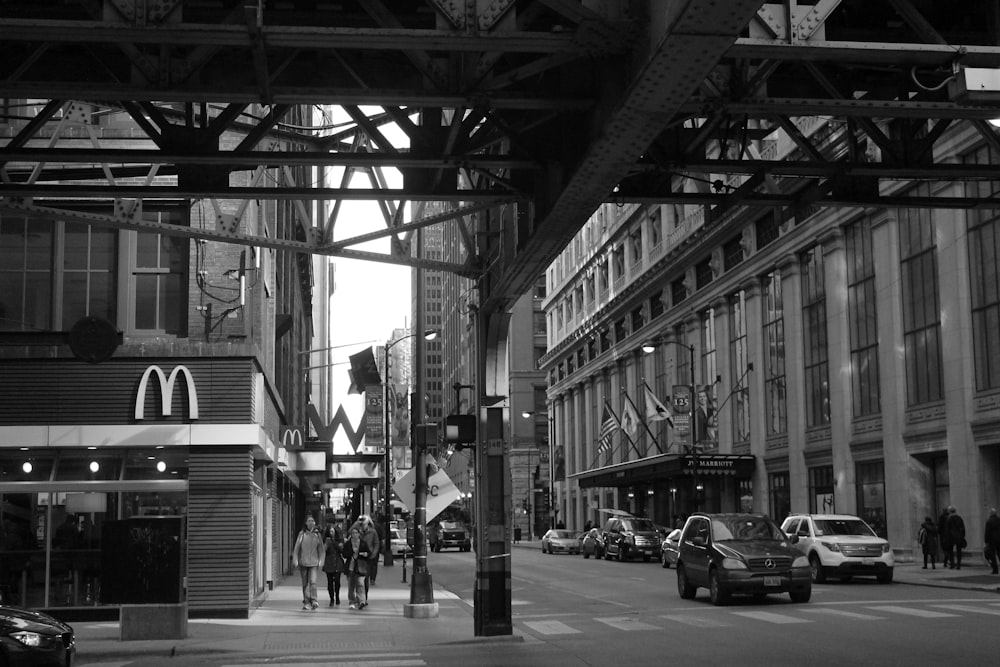 grayscale photo of people walking on street