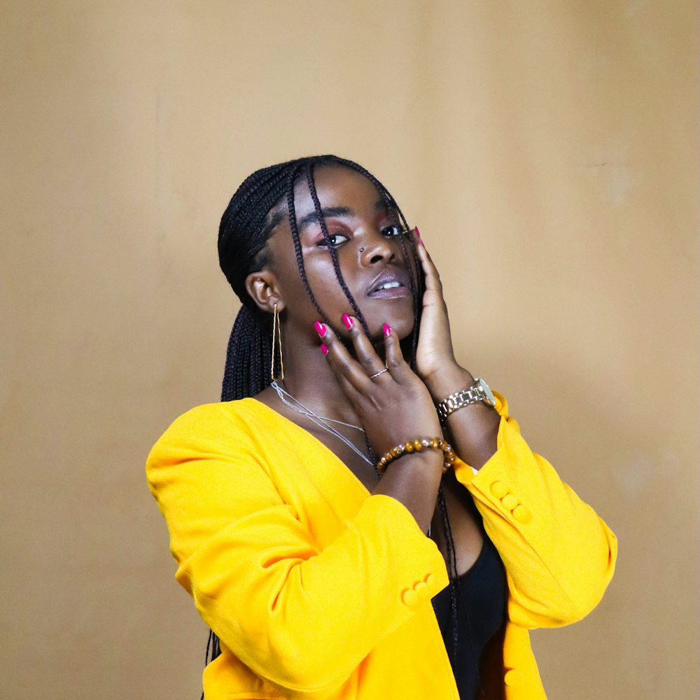 woman in yellow blazer wearing black headphones