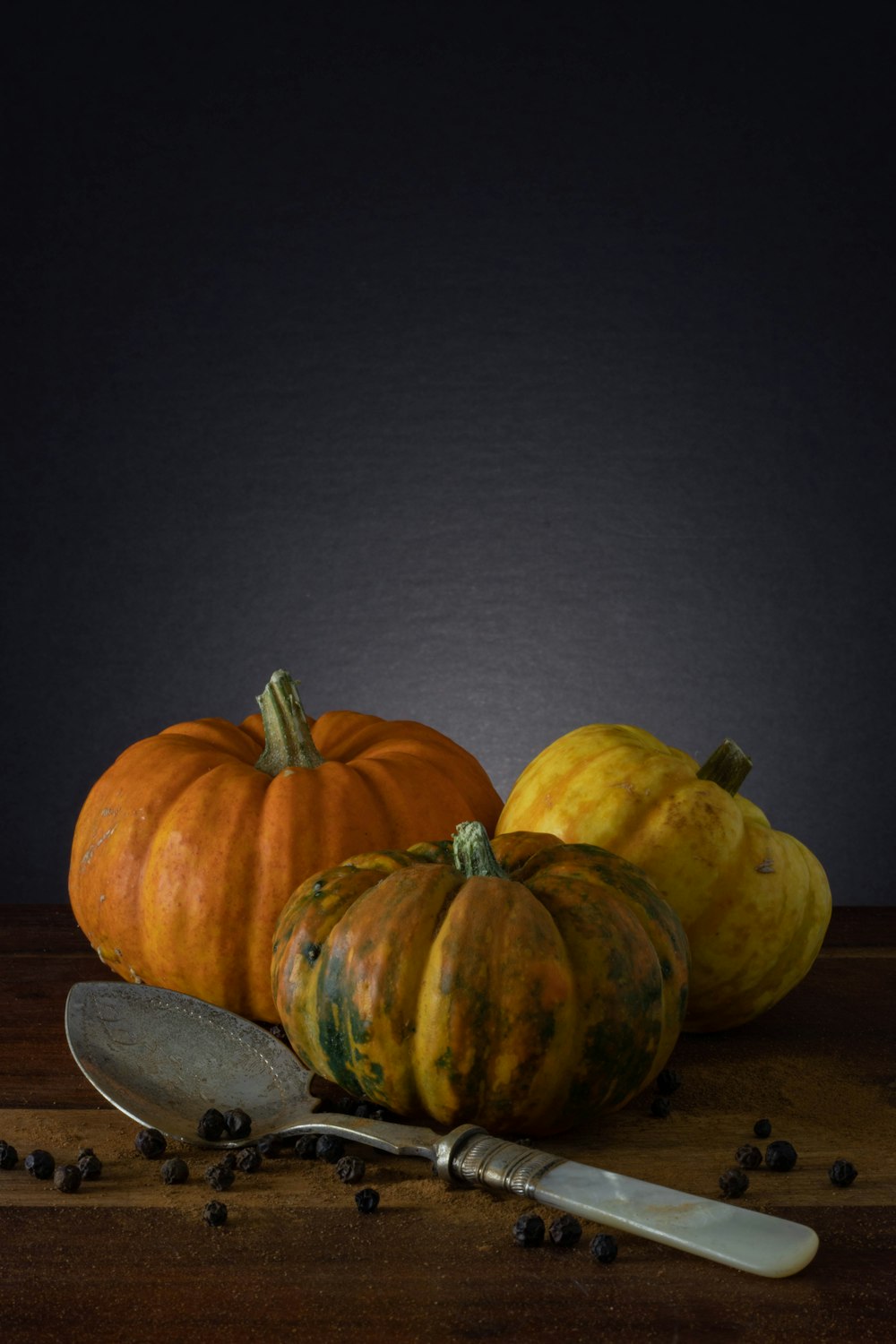 yellow and green pumpkin on brown wooden table