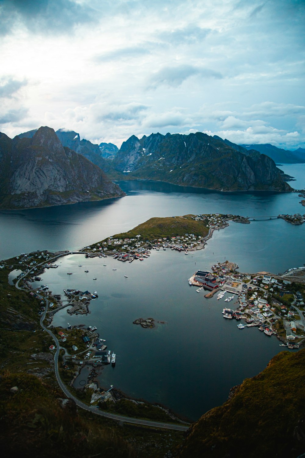 aerial view of green and brown mountains and body of water