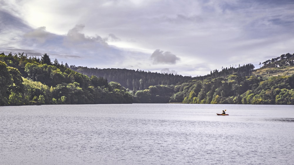 person riding on boat on sea during daytime