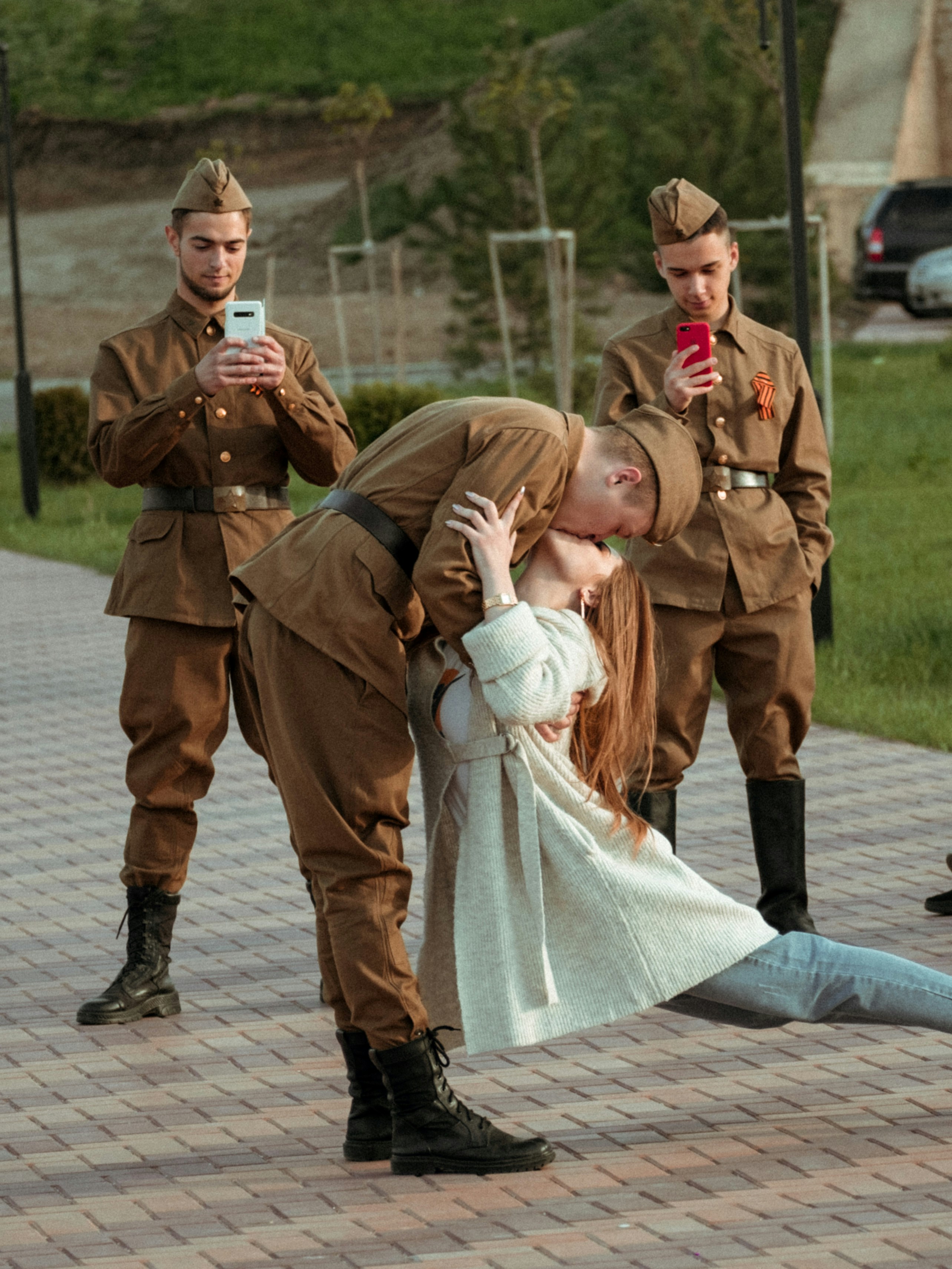 man and woman holding hands while walking on sidewalk during daytime
