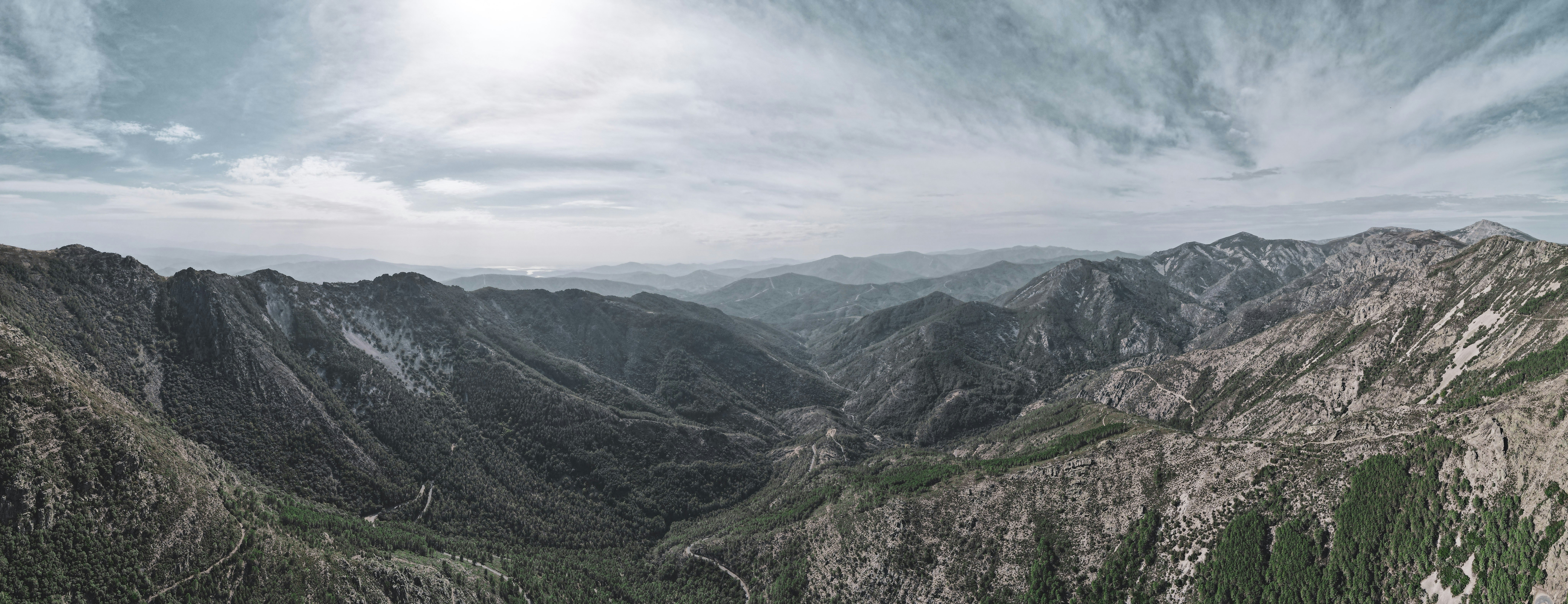Green mountains under clouds