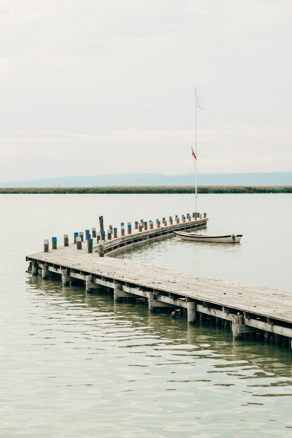 white and brown wooden dock on sea during daytime