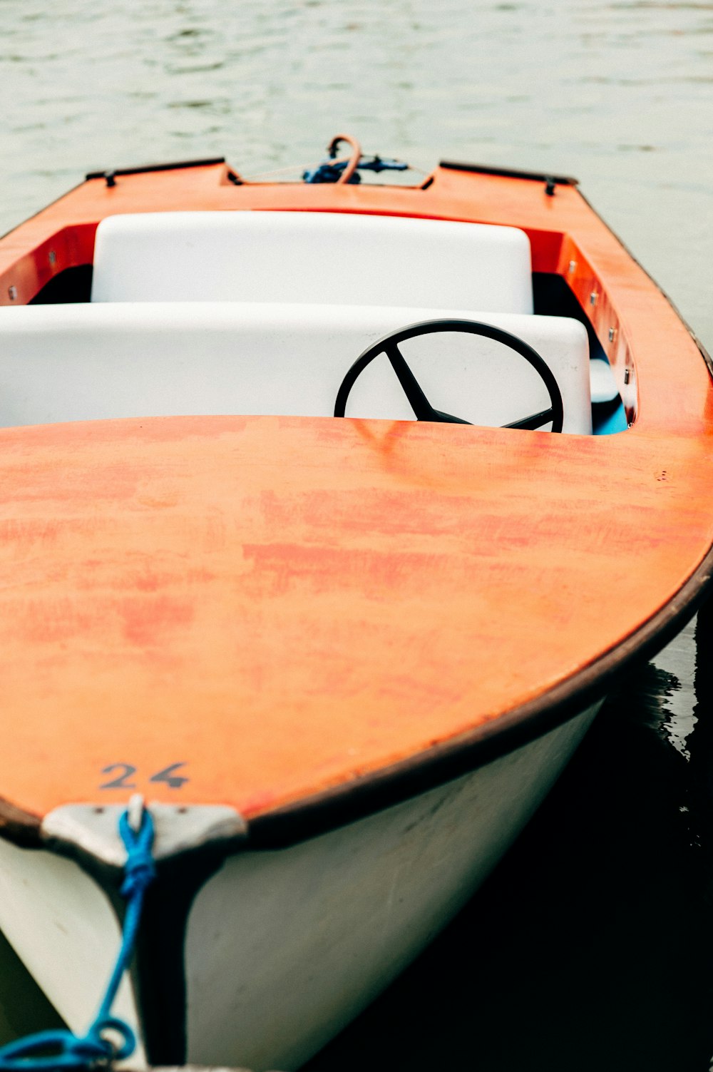 white and orange boat on water