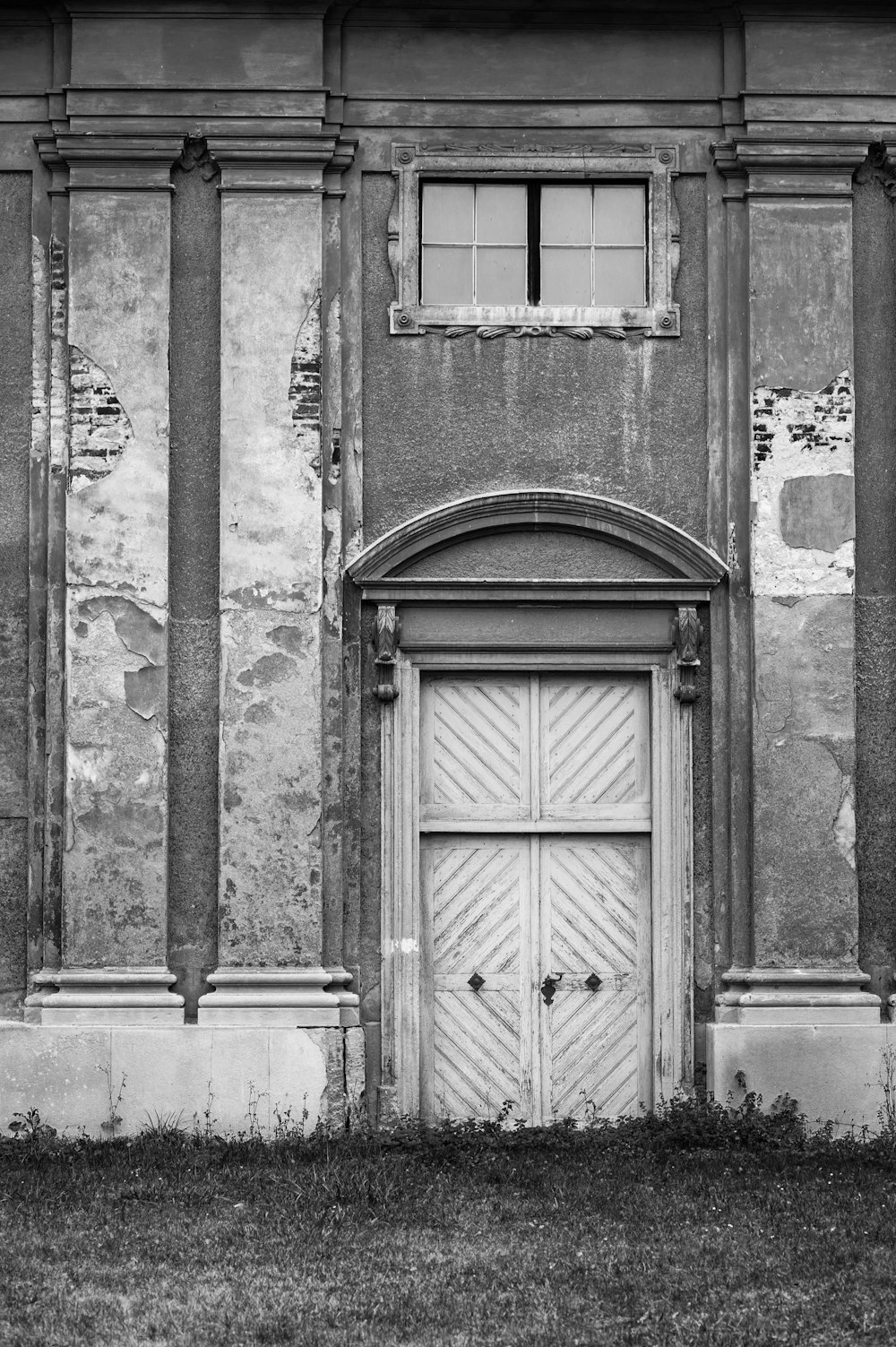 grayscale photo of wooden door