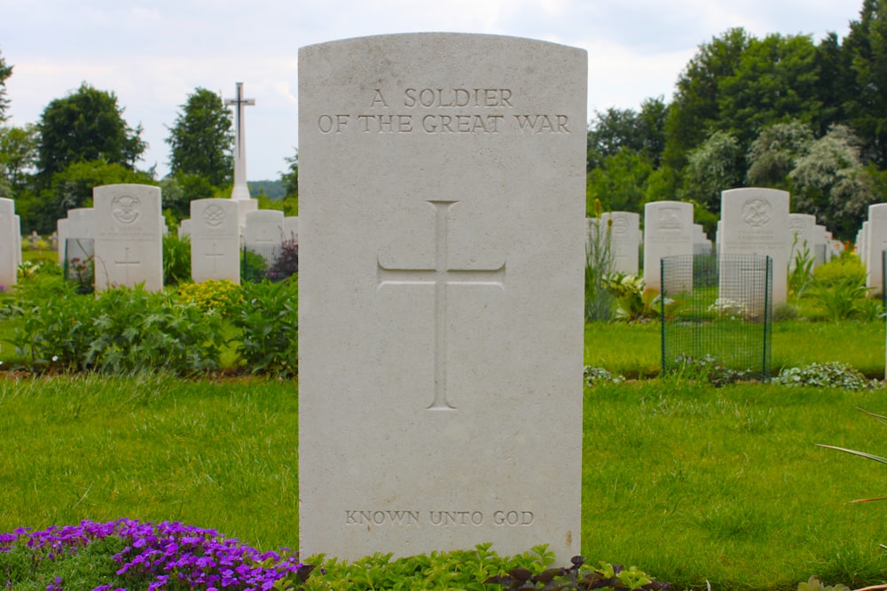 gray tomb stone on green grass field during daytime