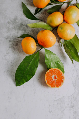 orange fruits on white surface