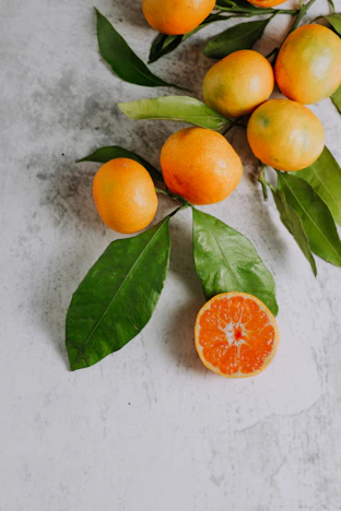 orange fruits on white surface