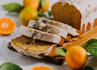 sliced bread with sliced orange fruit on white ceramic plate