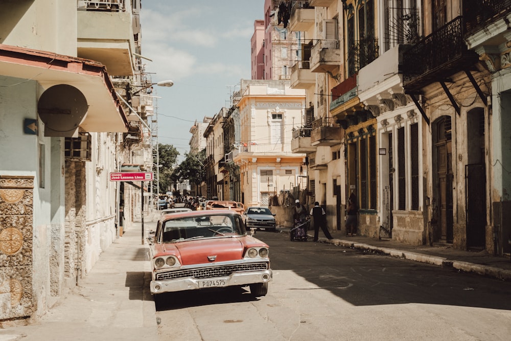 red car parked on street during daytime