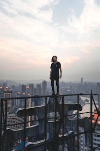 A confident business leader overlooking a city skyline at dawn, symbolizing strategic clarity and strength.