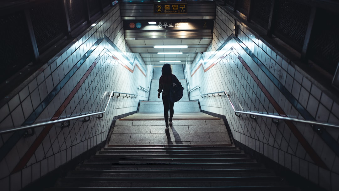 man in black jacket walking on the stairs