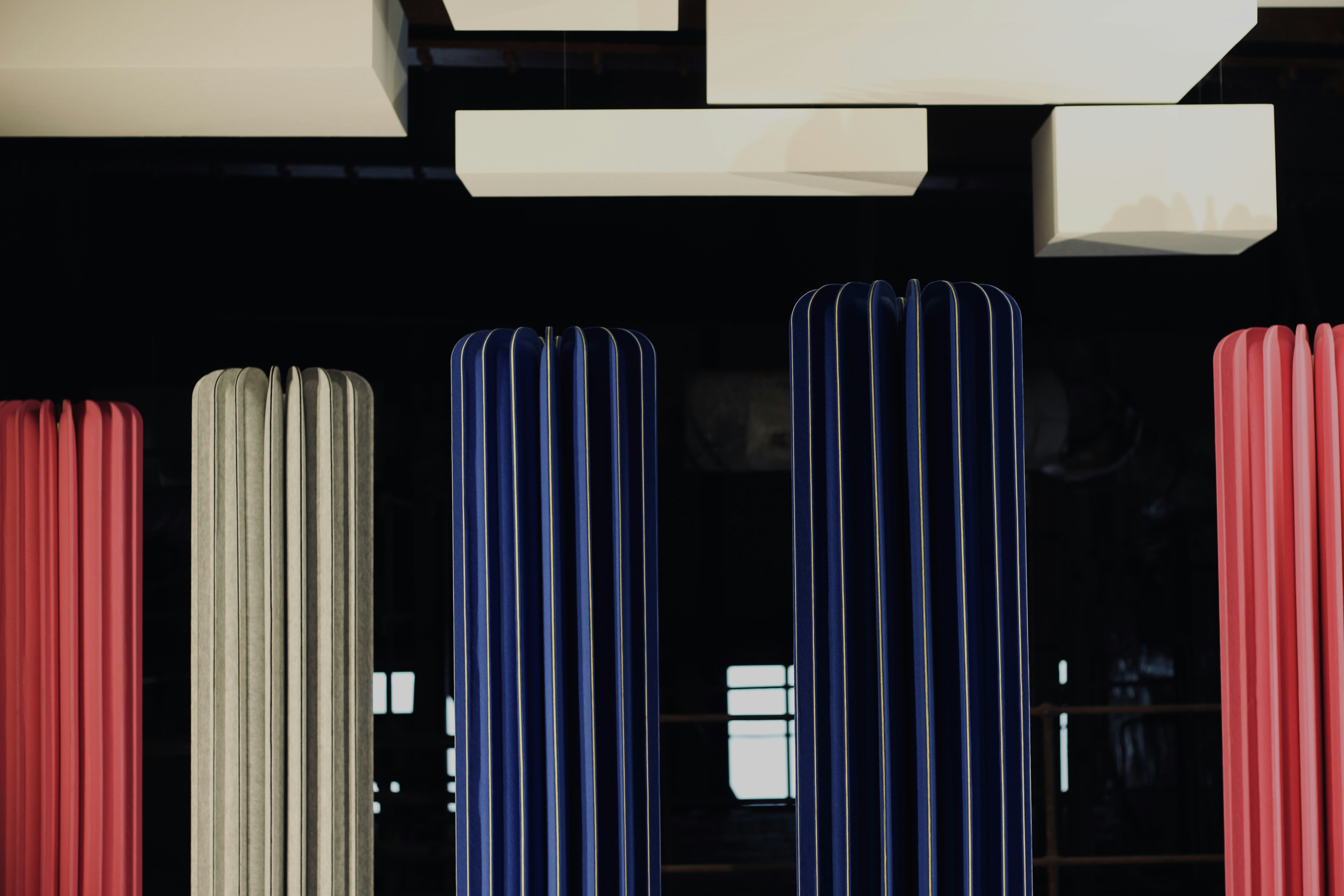 white wooden shelf with blue plastic chairs