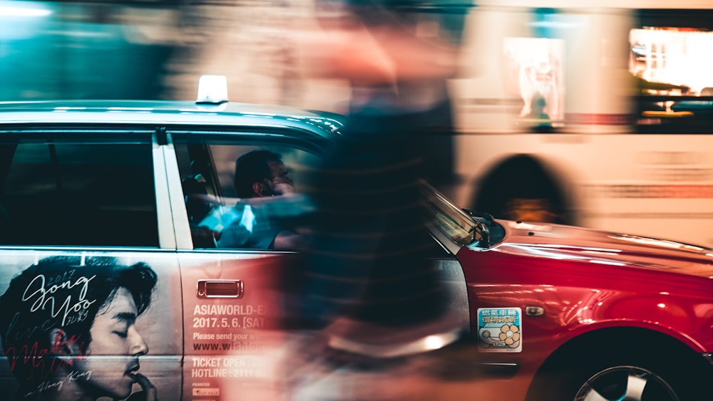 man in black and red striped long sleeve shirt driving red car