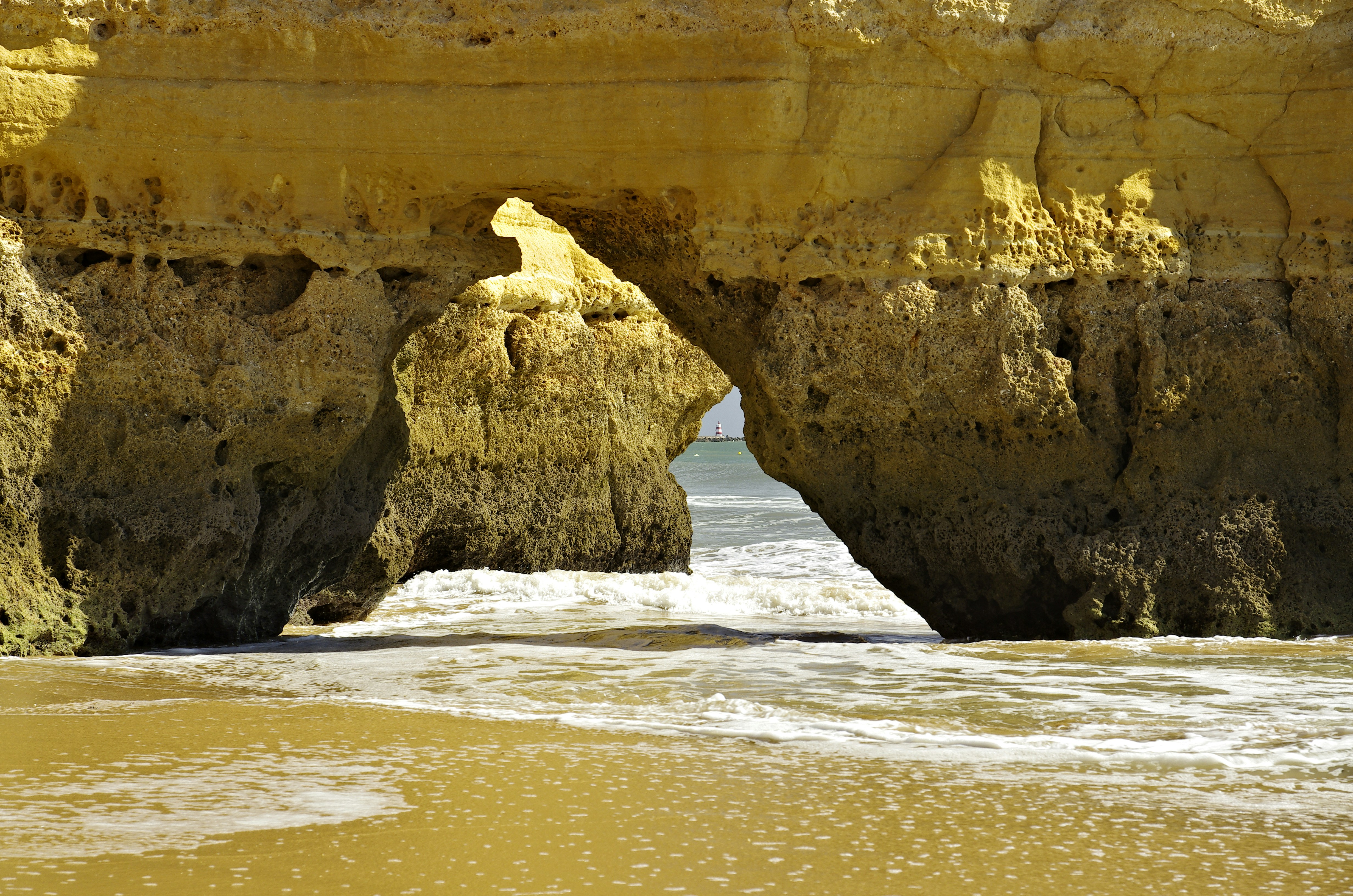 brown rock formation on sea shore during daytime coast teams background