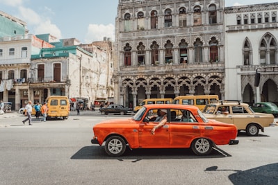 A vibrant illustration of a classic car on a city street.