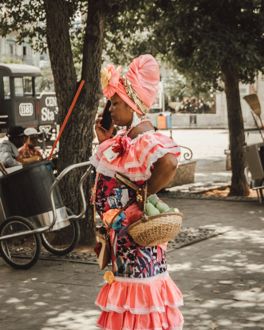 girl in pink and white dress standing on sidewalk during daytime