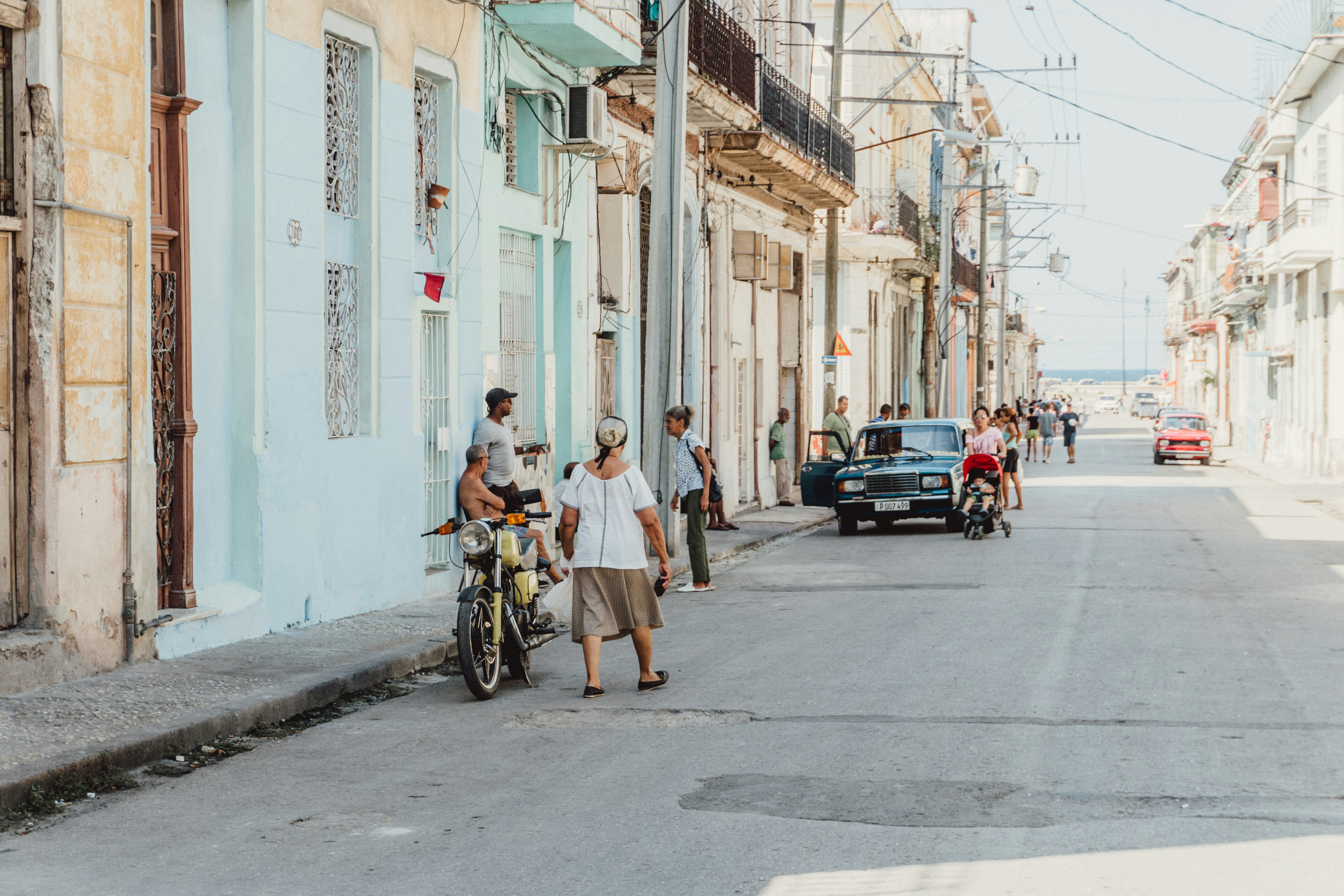 man in blue shirt riding bicycle during daytime