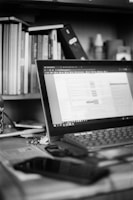 Modern office workspace with a laptop and business documents on a desk.