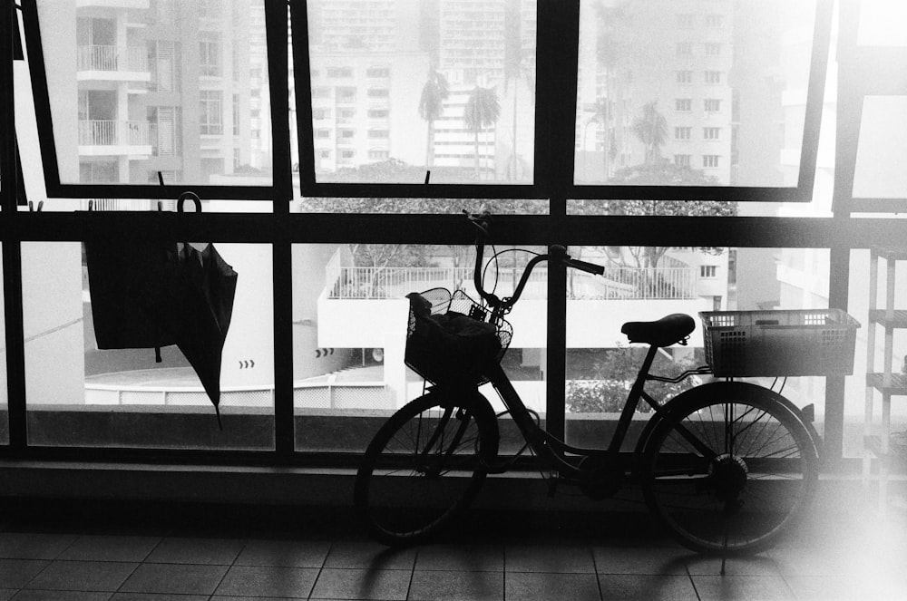 black city bike in front of glass window