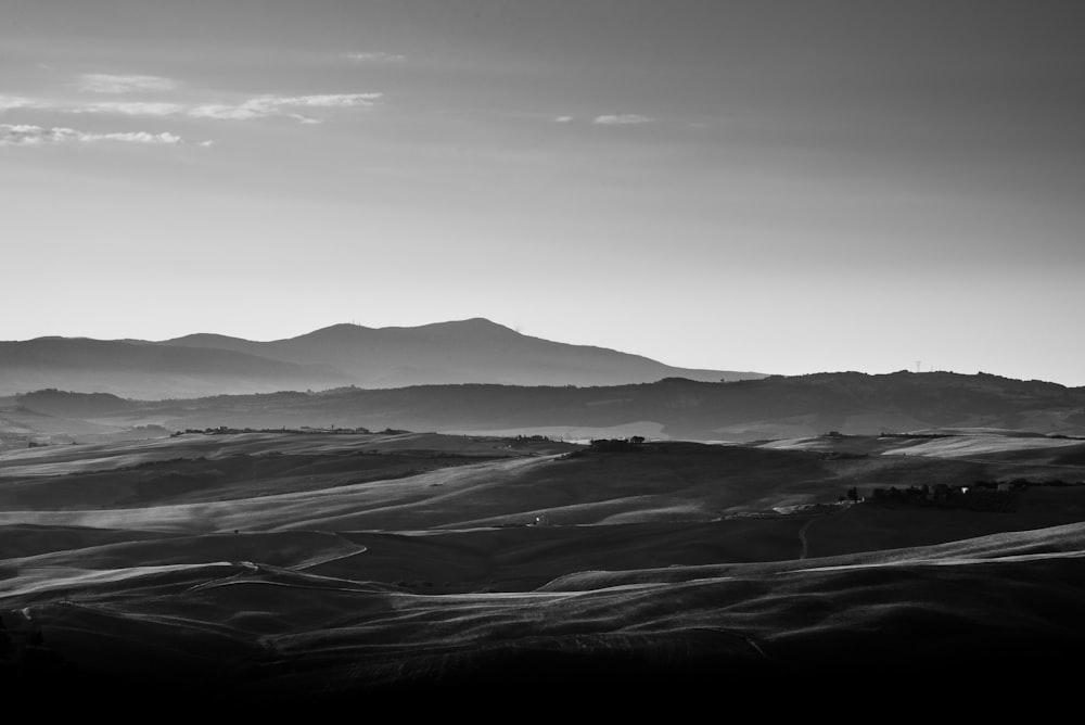 grayscale photo of mountains and clouds