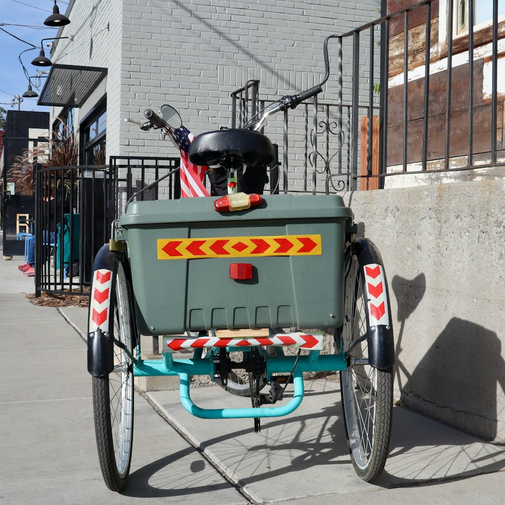 red and black trike on sidewalk during daytime