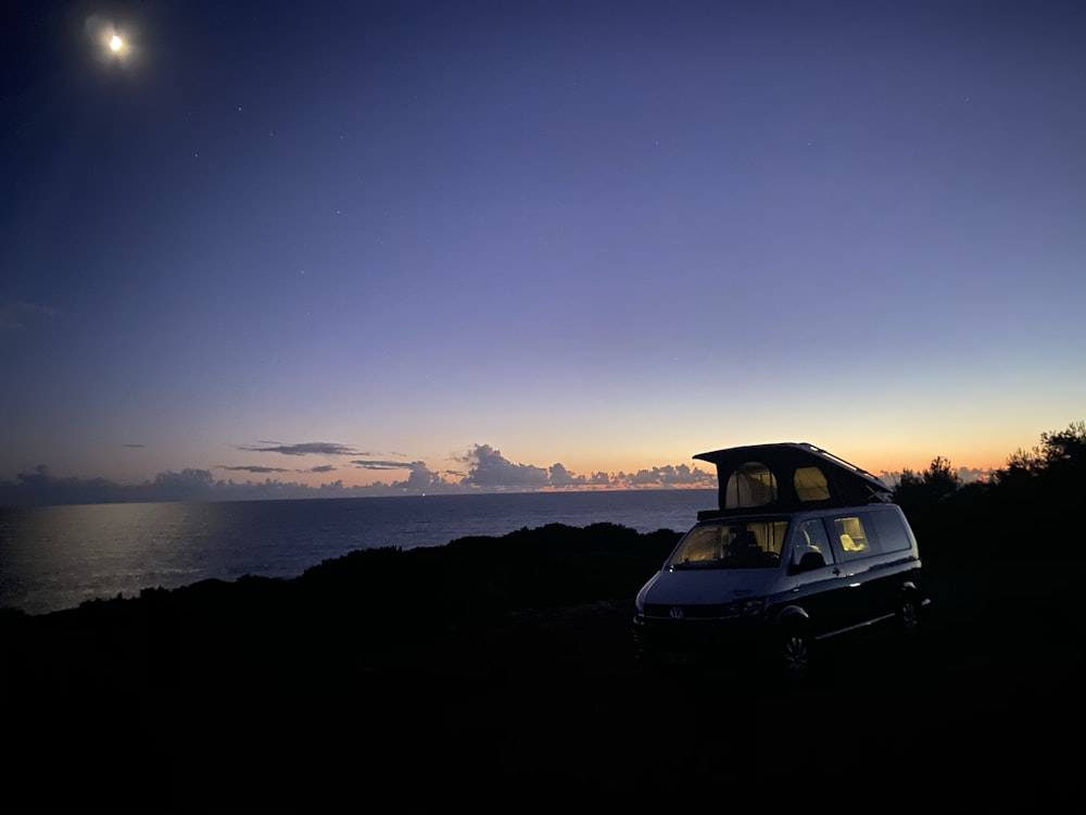 black car on the road during sunset