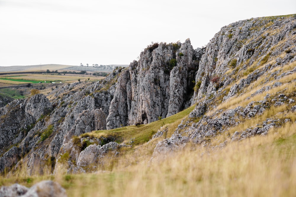 green and gray mountain beside body of water during daytime