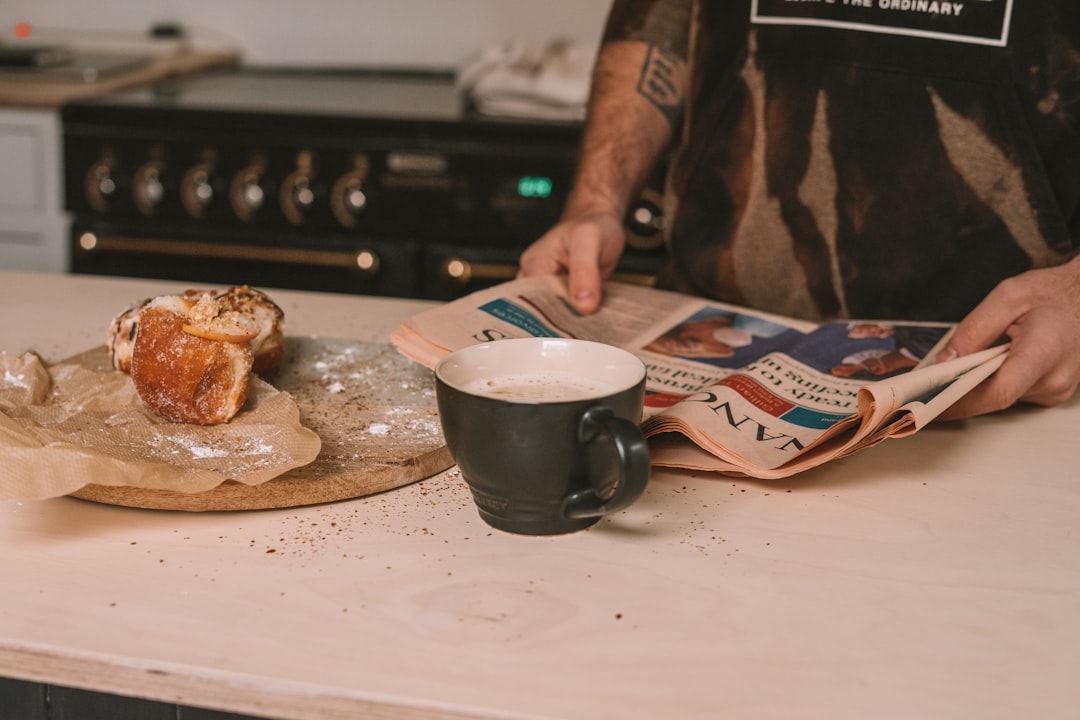 person holding blue and white ceramic mug