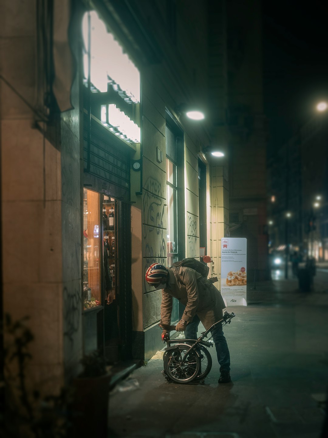 man in black jacket riding bicycle on road during nighttime