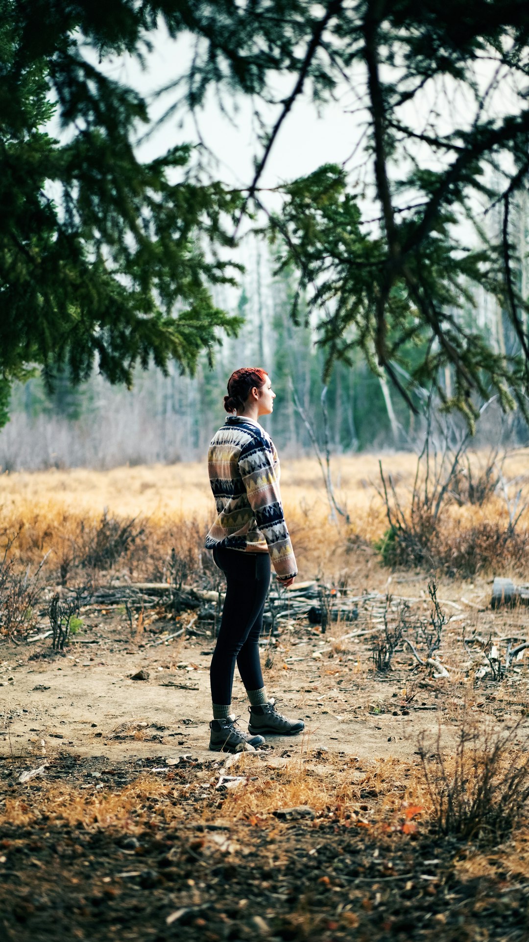 man in brown and white plaid dress shirt and black pants walking on dirt road during