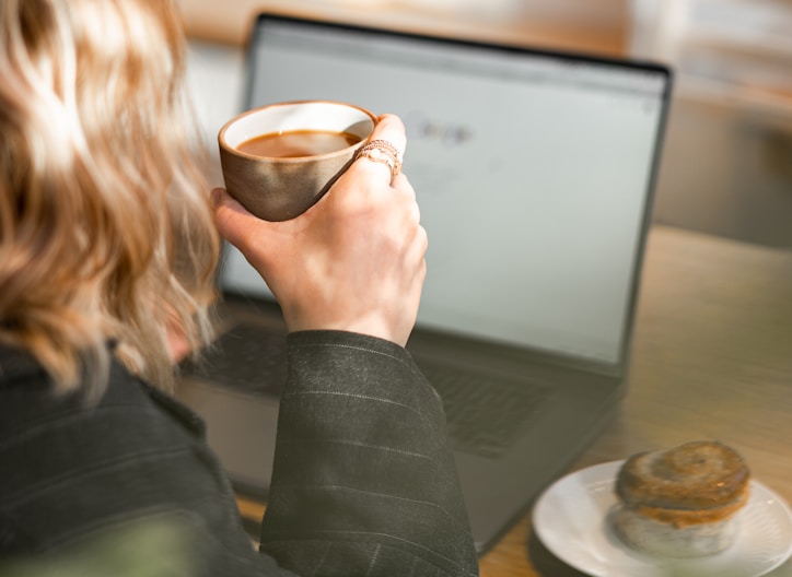 woman in black blazer sitting at the table