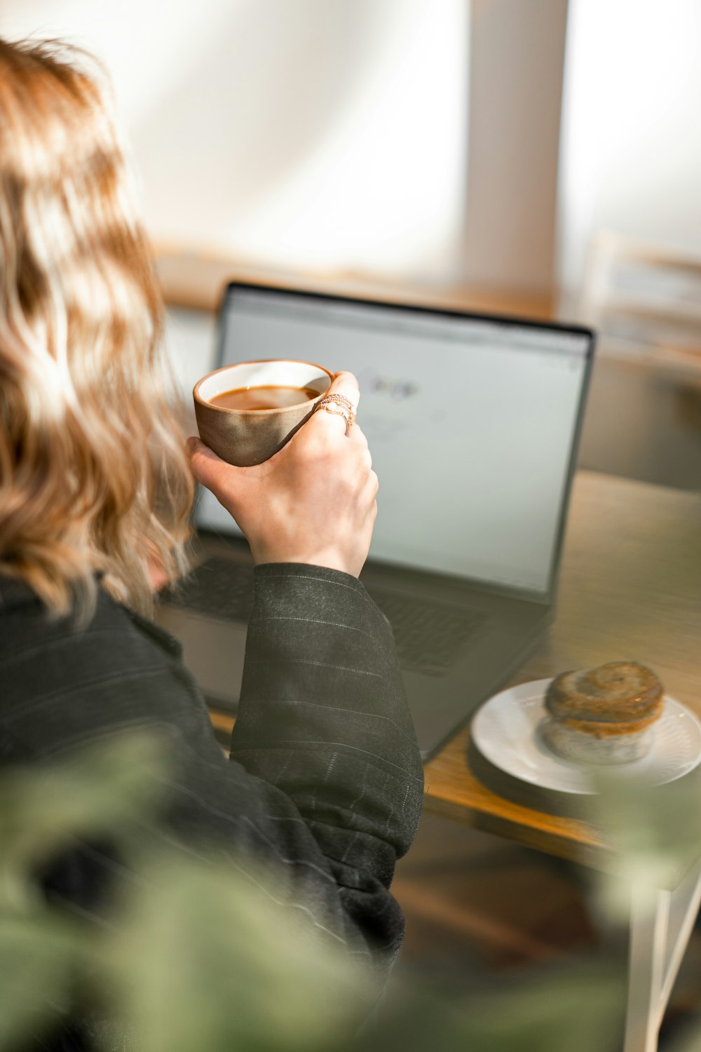 woman in black blazer sitting at the table