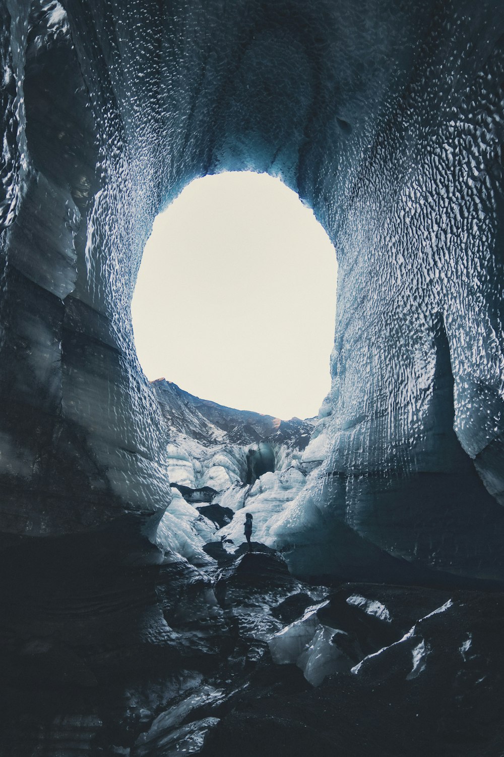 cave with snow during daytime