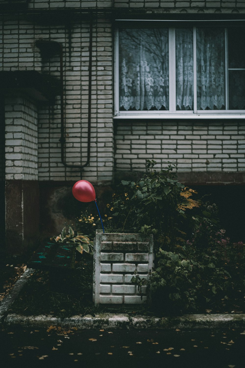 red ball on brown brick building
