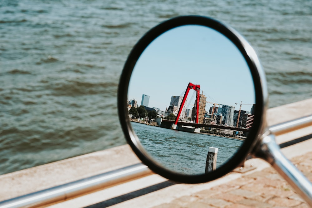 a view of a bridge in a rear view mirror