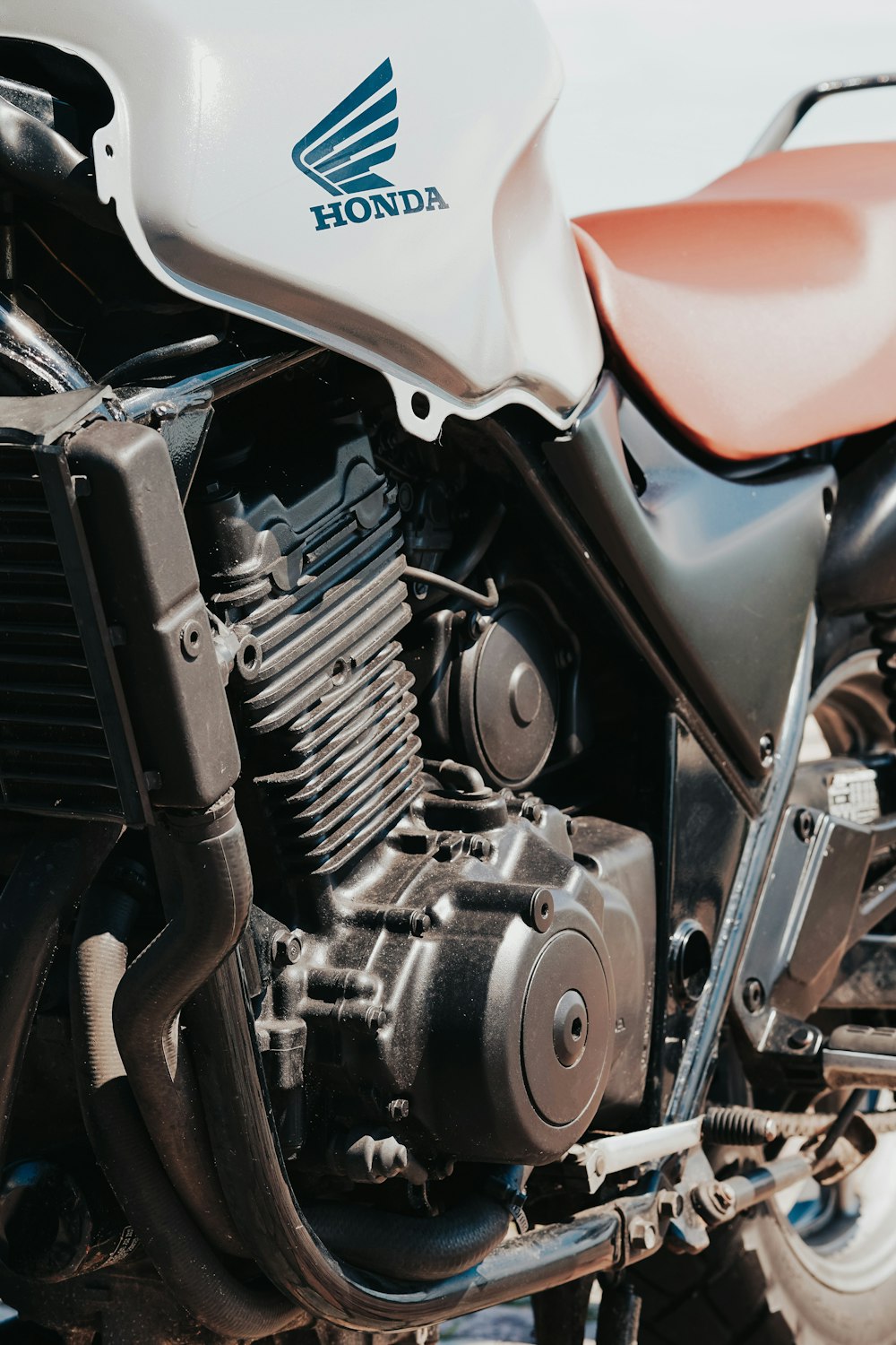 a close up of a motorcycle parked in a parking lot