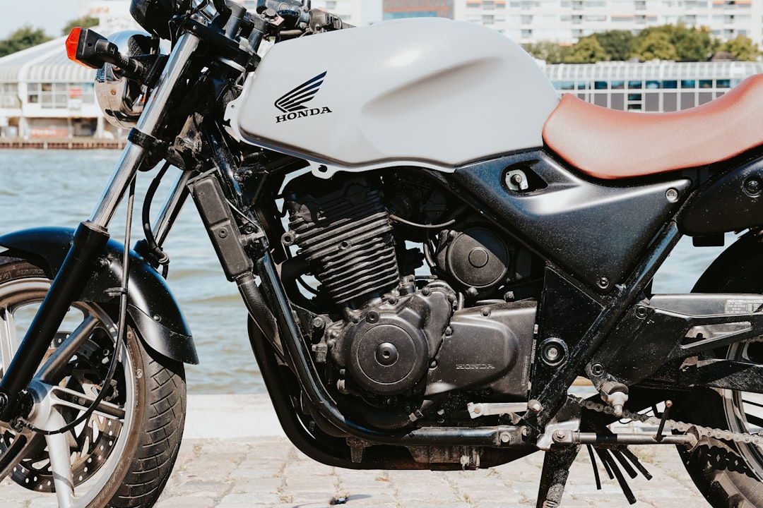 black and red motorcycle on brown concrete floor