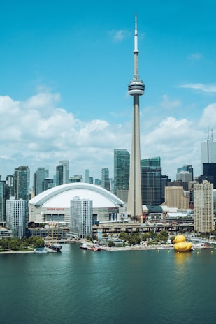 white and gray concrete building near body of water during daytime