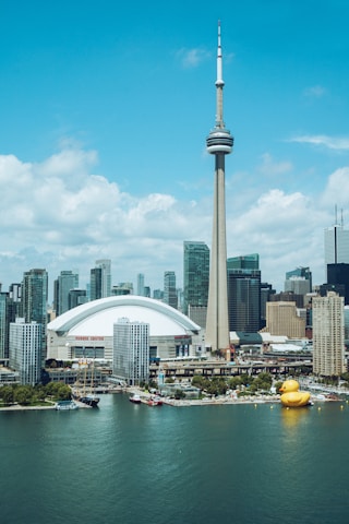 white and gray concrete building near body of water during daytime