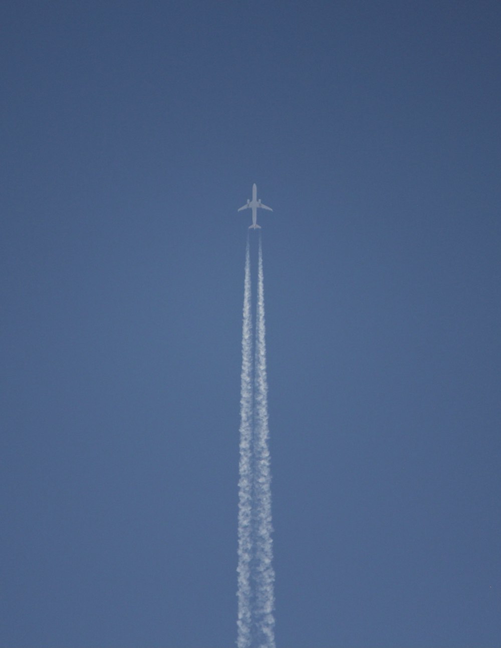 white wind turbine under blue sky